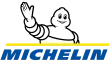 A Michelin logó, amelyen a Michelin ember üdvözöl, fehér háttér előtt.