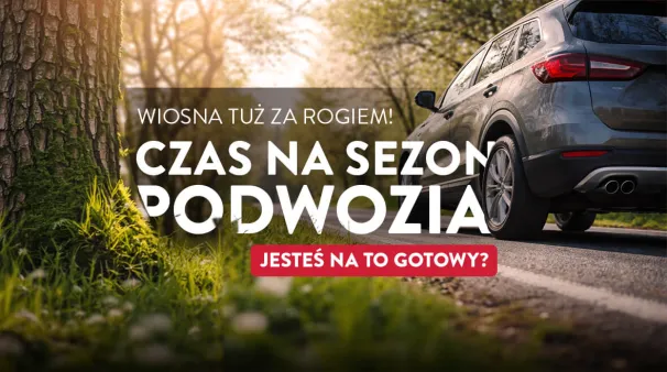 Samochód na drodze wiosennej, z drzewami w tle, zapowiada sezon podwozia.