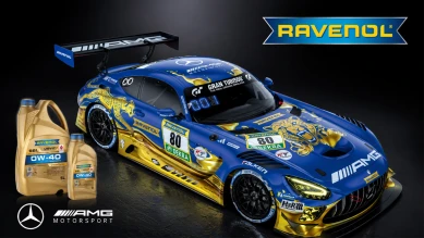 Mėlynos ir auksinės spalvos Mercedes AMG lenktyninis automobilis su Ravenol prekės ženklu ir alyvos buteliais pirmame plane.