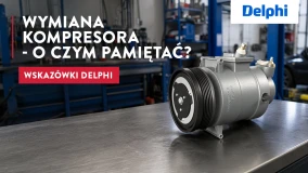 Kompresor Delphi wystawiony na stole warsztatowym, a narzędzia w tle.